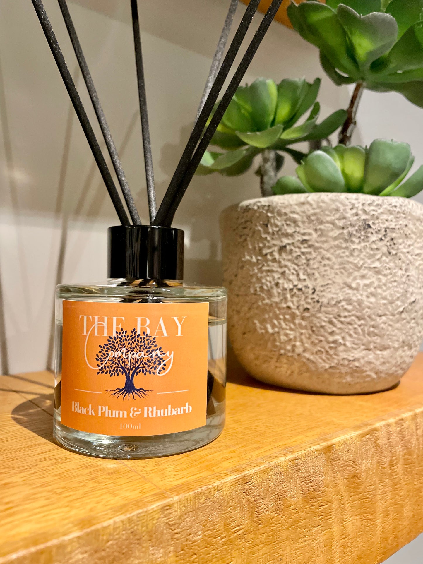 The Bay Company reed diffuser with a fruity scent. Black plumb and rhubarb.