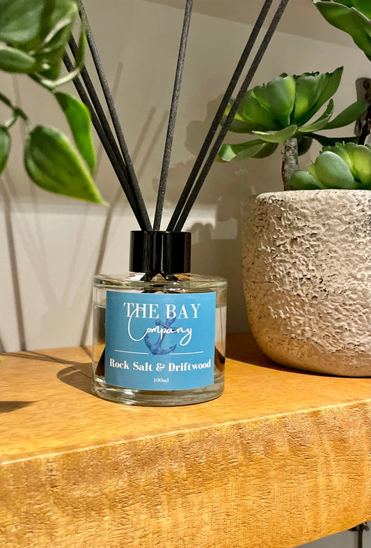 The Bay Company reed diffuser with a salty seaside scent. Rock salt and driftwood. 